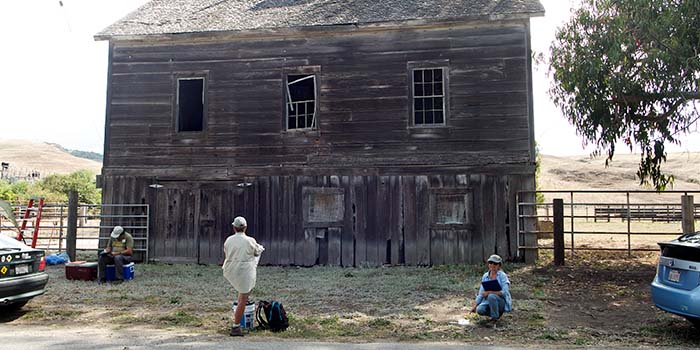 Site stewards taking notes on the condition of an historic building